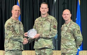 Air Force Lt. Gen. Stephen Davis (left), Department of the Air Force Inspector General, and Chief Master Sgt. Michael MacNeil (right), Headquarters Air Force IG senior enlisted leader, present the Lt. Gen. Howard W. Leaf Award in the wing-level officer category to Alaska Air National Guard Lt. Col. Eric Manewal May 16, 2024, in Leesburg, Va., Manewal is the 176th Wing Inspector General director of inspections. (Courtesy photo)

