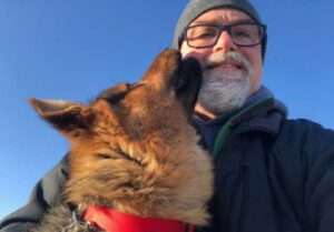 Gregory Pietsch visits with his dog, Utqi.