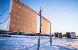 Photo by Jeff Fisher Light from the setting sun strikes vertically mounted, bifacial PV systems at the Solar Photovoltaic Test Site in Fairbanks in 2023.
