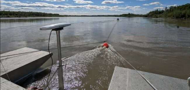 Photo by Ben Loeffler The research barge at the Tanana River Test Site near Nenana points upstream in 2023. Testing of prototypes at the site helps technology developers create systems that are ready for pilot deployments.