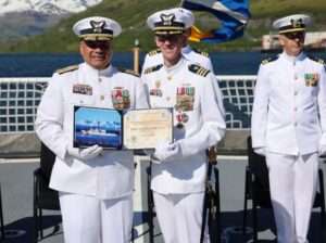 Cmdr. Steven Baldovsky, commanding officer, Coast Guard Cutter Alex Haley (WMEC-39) is presented with an award by Vice Adm. Andrew Tiongson, commander, Coast Guard Pacific Area, during the change of command ceremony for the Alex Haley in Kodiak, Alaska, June 5, 2025. Alex Haley is a 282-foot Medium Endurance Cutter that performs search and rescue, fisheries law enforcement, and maritime security. (U.S. Coast Guard photo by Lt. j.g. John Walsh).