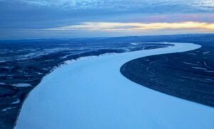 Photo by Ben Loeffler
The frozen Yukon River winds through Interior Alaska just upstream from the village of Galena in December 2024. The under-ice hydrokinetics project aims to develop a technology that can produce electricity from the water moving under the frozen surface.