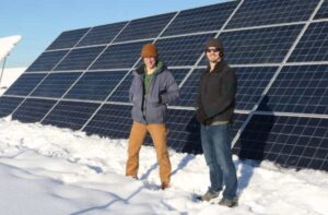 Photo by Amanda Byrd
Golden Valley Electric Association’s Nathan Minnema, right, and ACEP intern Dan Manley stand in front of one of 40 solar panels that made up the utility's 563-kilowatt solar farm in 2019.