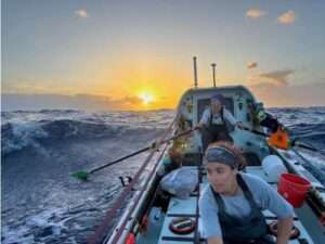 Photo courtesy of Noelle Helder
Lauren Shea, foreground, and Noelle Helder row into the sunset as they cross the Atlantic Ocean as part of a four-woman team.