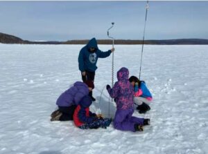 Photo by Sarah Clement
Students at Jack Egnaty Sr. School collect ice thickness and snow depth measurements on the Kuskokwim River near Sleetmute for the Fresh Eyes on Ice project.