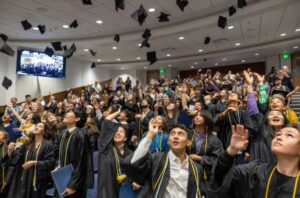 UAF photo by Eric Engman
Graduates toss their caps during the 42nd Rural Alaska Honors Institute graduation ceremony July 11, 2024, in the Schaible Auditorium on the University of Alaska Fairbanks campus.