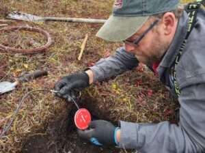 Photo by Amanda Young/TFS
Environmental Data Center technician Colin Edgar installs equipment to measure soil heat exchange for the European Union’s Arctic Passion project at Toolik Field Station in September 2023.