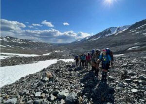 Photo by Danielle Johnson
Girls on Ice 2024 participants hike up the rubble-covered C’ulc’ena’ Luu’ (Gulkana Glacier).