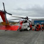 JOINT BASE ELMENDORF-RICHARDSON, Alaska - A U.S. Coast Guard Air Station Kodiak MH-60 Jayhawk helicopter aircrew and Alaska Air National Guard pararescuemen prepare to depart on a flight in Adak. (U.S. Coast Guard photo by Lt. Cmdr. Tanner Evans)
