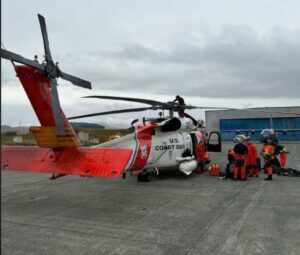 JOINT BASE ELMENDORF-RICHARDSON, Alaska - A U.S. Coast Guard Air Station Kodiak MH-60 Jayhawk helicopter aircrew and Alaska Air National Guard pararescuemen prepare to depart on a flight in Adak. (U.S. Coast Guard photo by Lt. Cmdr. Tanner Evans)