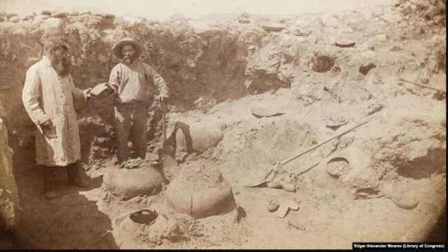This circa 1884-1886 photo by Army surgeon/naturalist Edgar Alexander Mearns shows two unidentified men, possibly Mearns himself on right, excavating pre-Columbian ruins in central Arizona's Verde River Valley.

