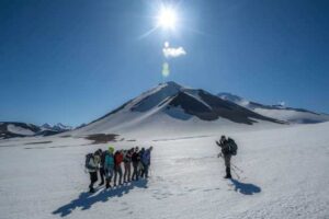 Photo by Seth Adams
Research associate professor Pavel Izbekov photographs students on the return from a day hike with Novarupta in the background.