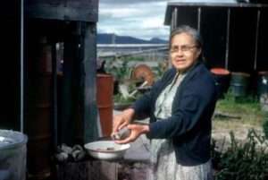 Photo: Christina Lukin opening clams. Afognak Village, ca. 1960. Chadwick Collection.
