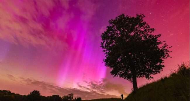 NASA Astronomy Photo of the Day by Mariusz Durlej
A red and rayed aurora was captured in a single 6-second exposure from Racibórz, Poland, during this weekend's intense solar storm. Northern lights don't usually reach so far south. The photographer's friend, seeing an aurora for the first time, is visible in the distance also taking images of the beautifully colorful nighttime sky. From NASA's Astronomy Picture of the Day.