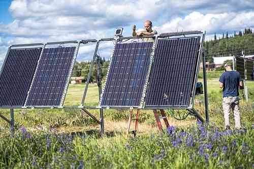 Photo by Jeff Fisher. ACEP’s Cole Sudkamp-Walker works on a solar panel at the Solar Photovoltaic Test Site on the University of Alaska Fairbanks Troth Yeddha’ campus.