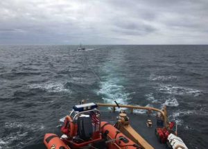 The crew of the Coast Guard Cutter Naushon tows four mariners after the Soulmate, their 48-foot commercial fishing vessel, became disabled and adrift approximately 57 miles west of Kodiak Island. Image-USCG