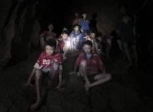 This July 2, 2018, photo released by Tham Luang Rescue Operation Center, shows the boys and their soccer coach as they were found in a partially flooded cave, in Mae Sai, Chiang Rai, Thailand