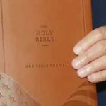 ‘Exploiting Religious Faith for Personal Profit,’ Trump Pockets $1.5 Million From Branded Bible President Donald Trump holds a “Good Bless the USA Bible,” a licensed product that he has earned $1.5 million from. (Photo via Lee Greenwood/YouTube)