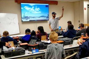 Matthew Westhoff, a pilot with UAF’s ACUASI, teaches students about drones at a camp in June. Photo by Patty Eagan.