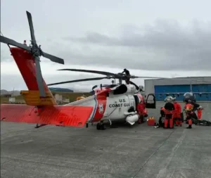 U.S. Coast Guard Air Station Kodiak MH-60 Jayhawk helicopter aircrew and Alaska Air National Guard pararescuemen prepare to depart on a flight in Adak, Alaska, Sep. 29. 2026. The two teams worked together to successfully medevac a cargo vessel captain experiencing a medical emergency 58 miles off the coast of Adak. (U.S. Coast Guard photo by Lt. Cmdr. Tanner Evans)