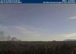 An FAA weather cam pointed to the southwest shows smoke from the crash site on Wednesday evening. Image-FAA
