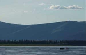 Cora the dog and Ned Rozell float down the Yukon River just upstream from Circle. Photo by Skip Ambrose.